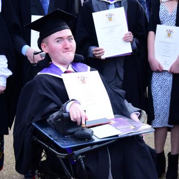 This is a photo of Ben in his wheelchair, graduating from university